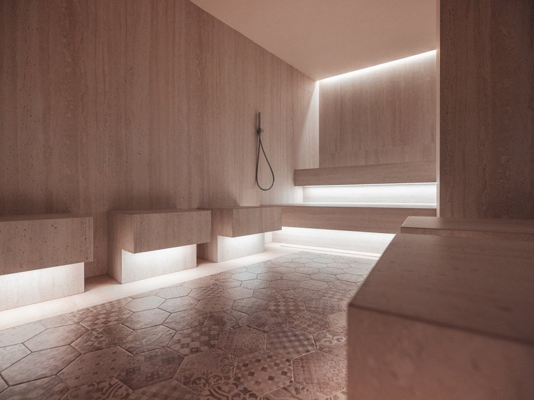 Il rituale dell’hammam al Latemar Hotel Interno moderno di sauna con pavimento in piastrelle esagonali e illuminazione soffusa