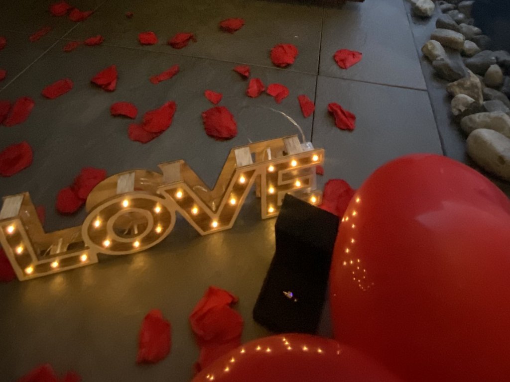 Dalla webcam il Latemar è bello, ma dal vivo è un sogno! Scenografia romantica con petali rossi, lettere illuminate LOVE e vista montagna innevata