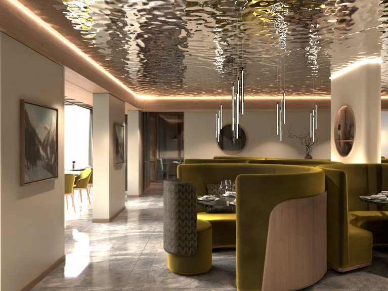 Ristorante a Soraga di Fassa: Mirage con #latermarview Interno di ristorante elegante con sedute verdi e soffitto riflettente