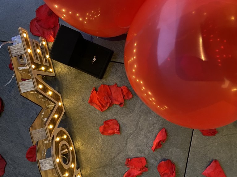 On the cycle track, from Moena to your romantic oasis Red balloons, rose petals, and an open box with an engagement ring