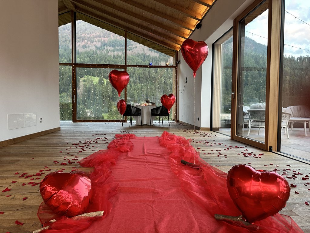 On the cycle track, from Moena to your romantic oasis Romantic pathway with heart balloons and rose petals in room with mountain view