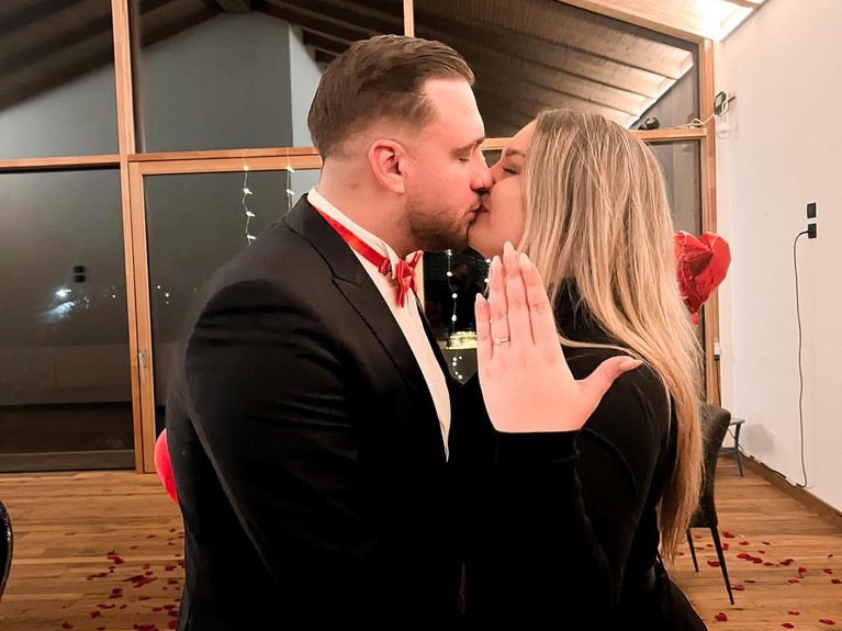 On the cycle track, from Moena to your romantic oasis Couple kissing, showing engagement ring with romantic decorations